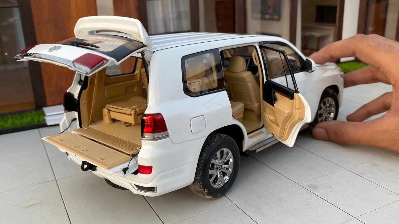White Land Cruiser SUV toy with opening doors and rear tailgate